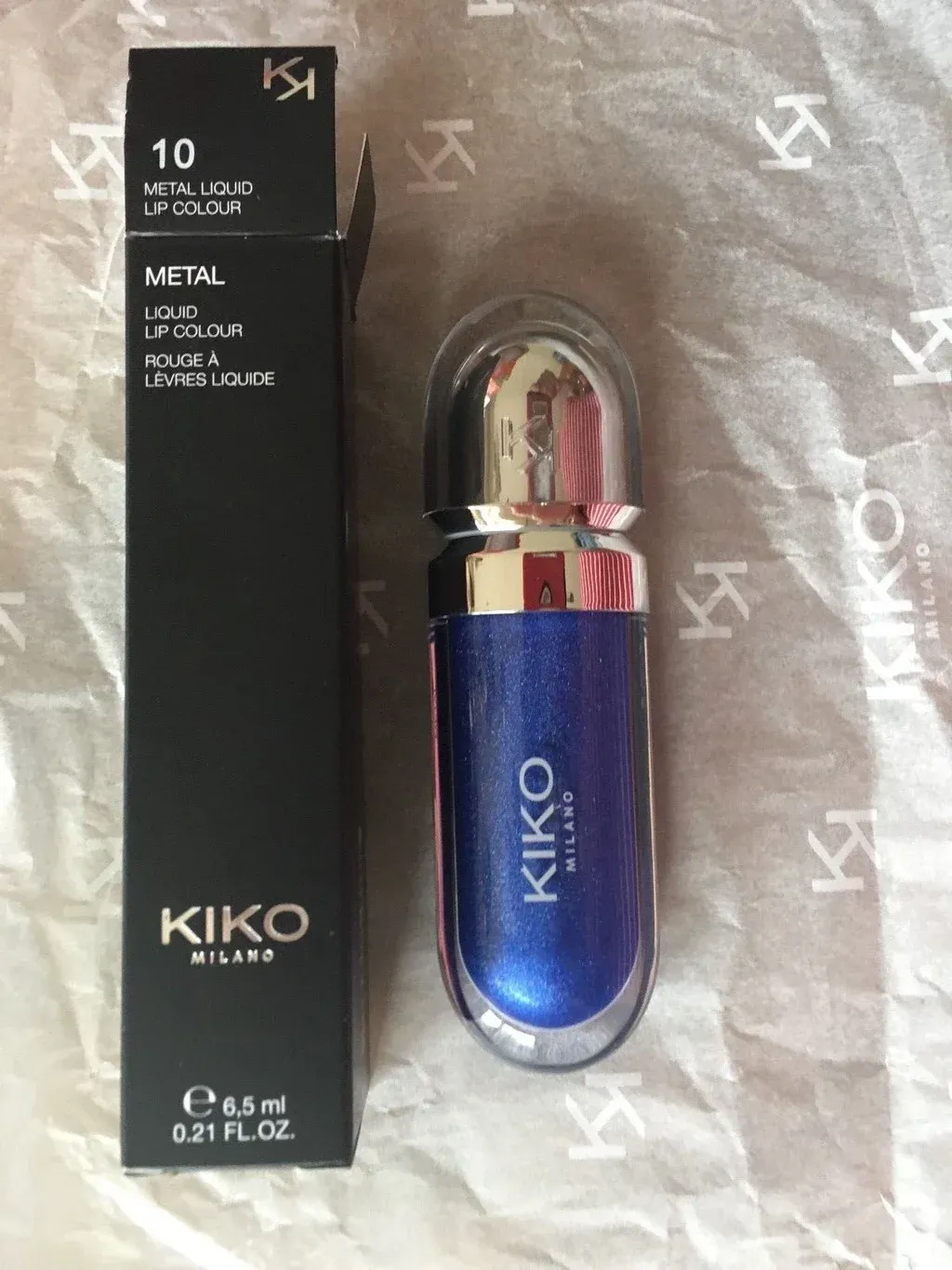 ATTACHED PRODUCT balancing against a circular chrome mirror on a — reference image