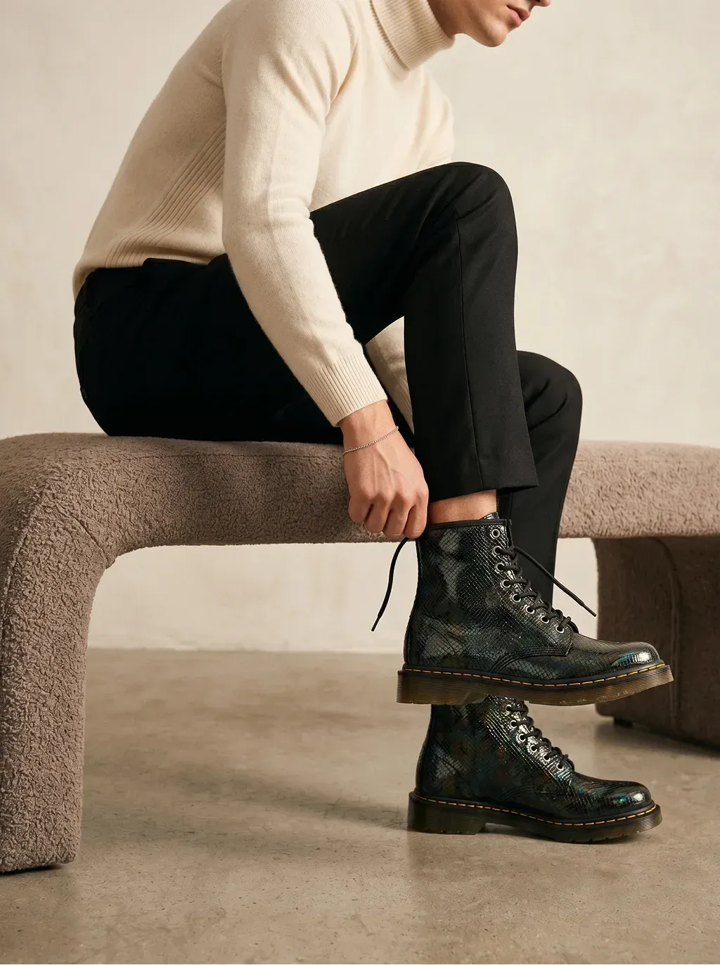 Editorial fashion photography of a young man in a cream