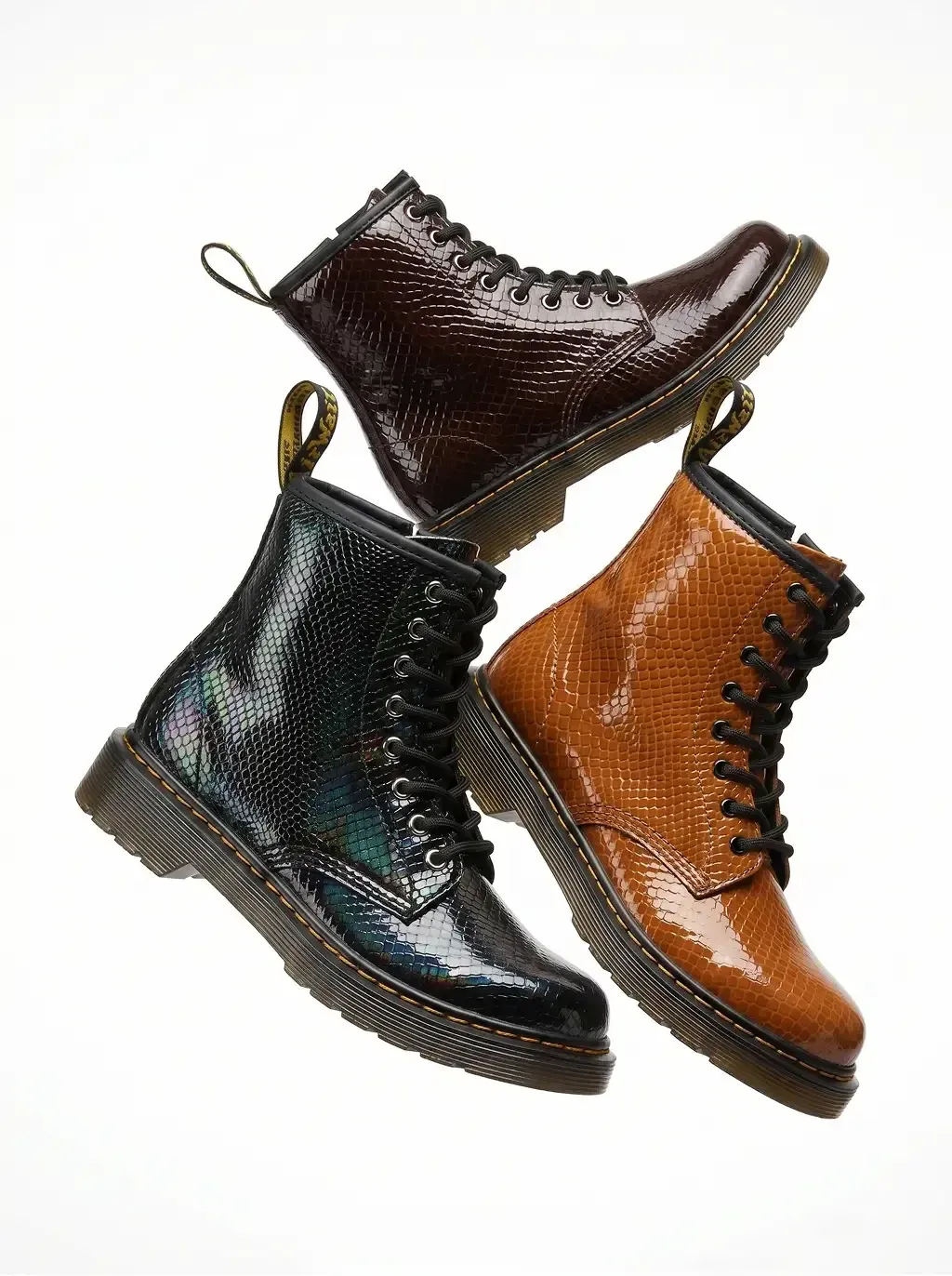 Studio product photography of three 8-eyelet lace-up combat boots in