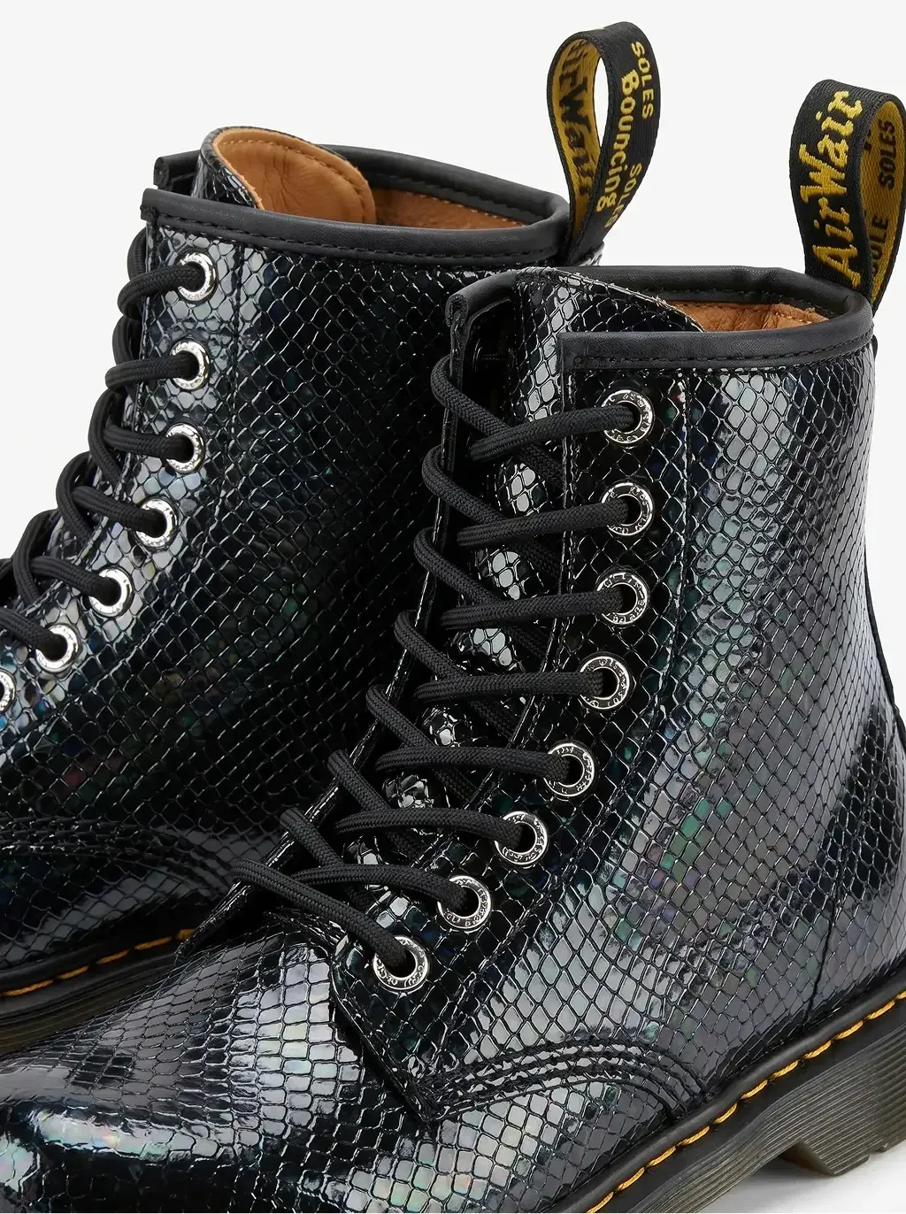 Extreme close-up macro product photography of two 8-eyelet lace-up combat