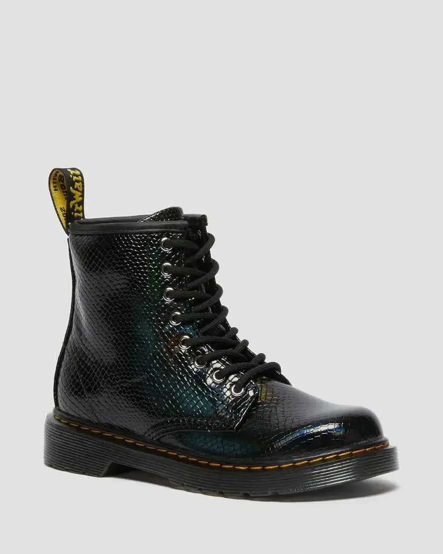 Studio product photography of three 8-eyelet lace-up combat boots with — reference image