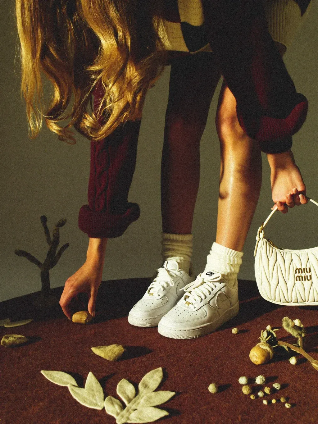 Surreal editorial fashion photograph cropped from the chest down, showing