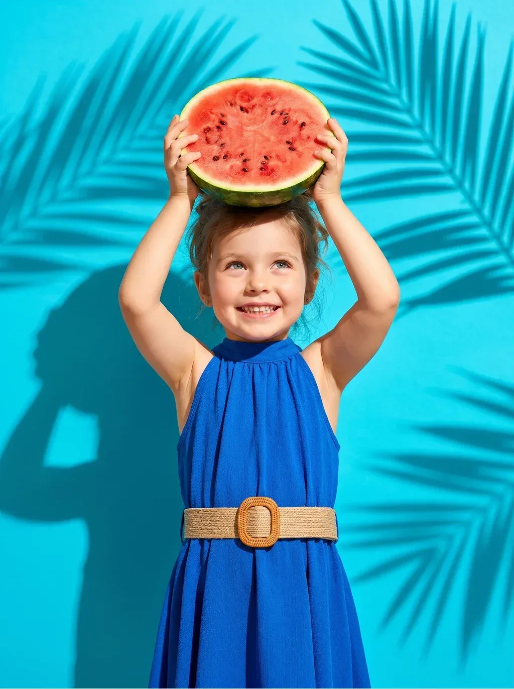 Summery editorial photograph of a cheerful little girl with wavy