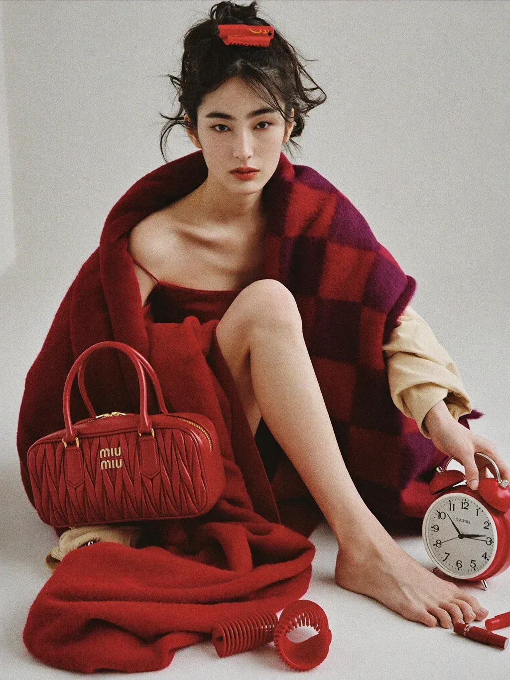 Editorial fashion photograph of a young woman sitting on the