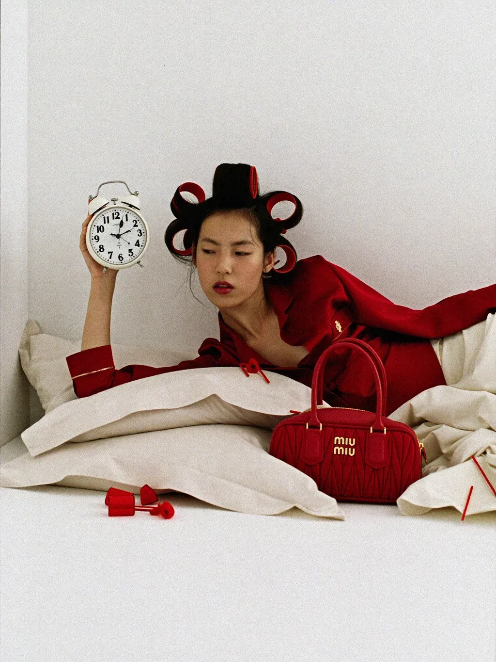 Editorial fashion photograph of a young woman lying on her