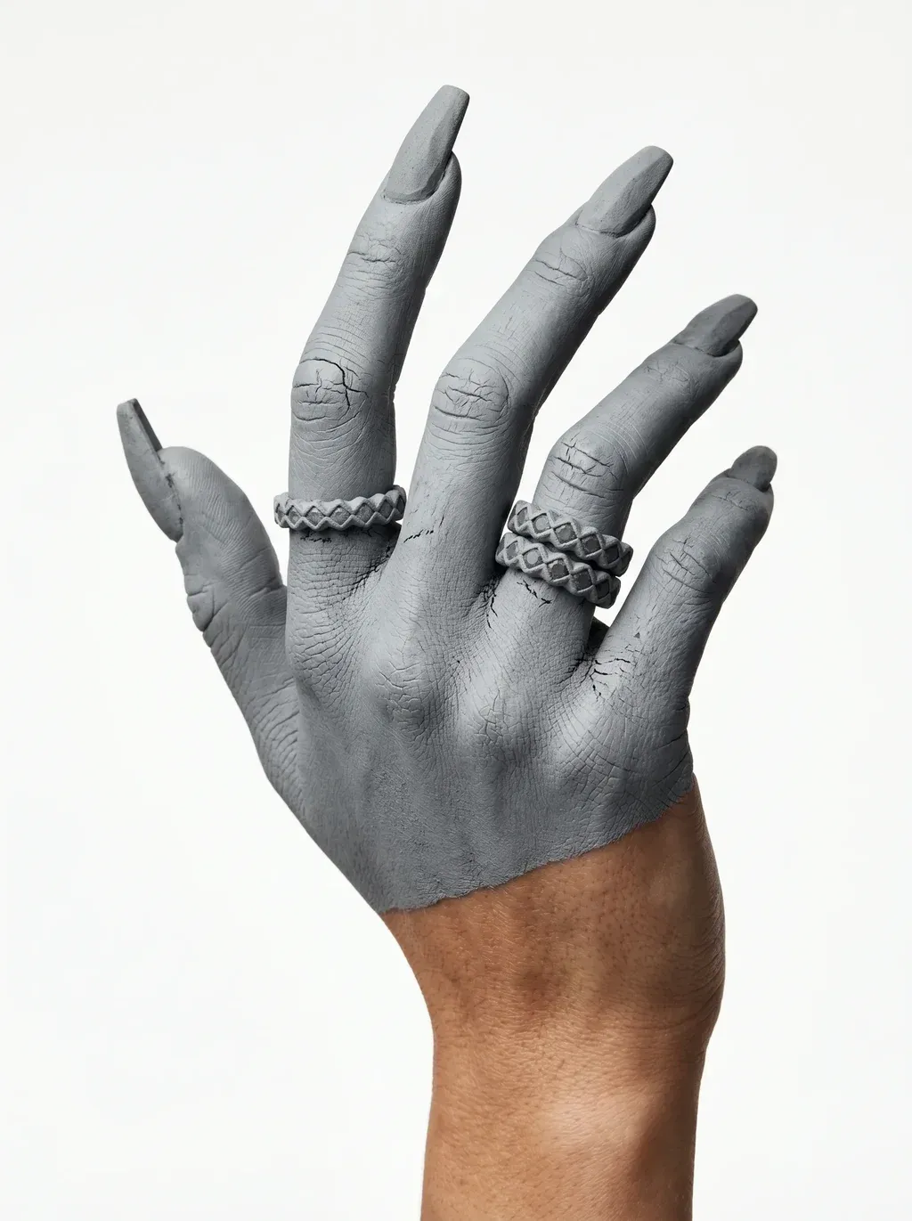 A high-fashion jewelry editorial photograph of a hand and forearm