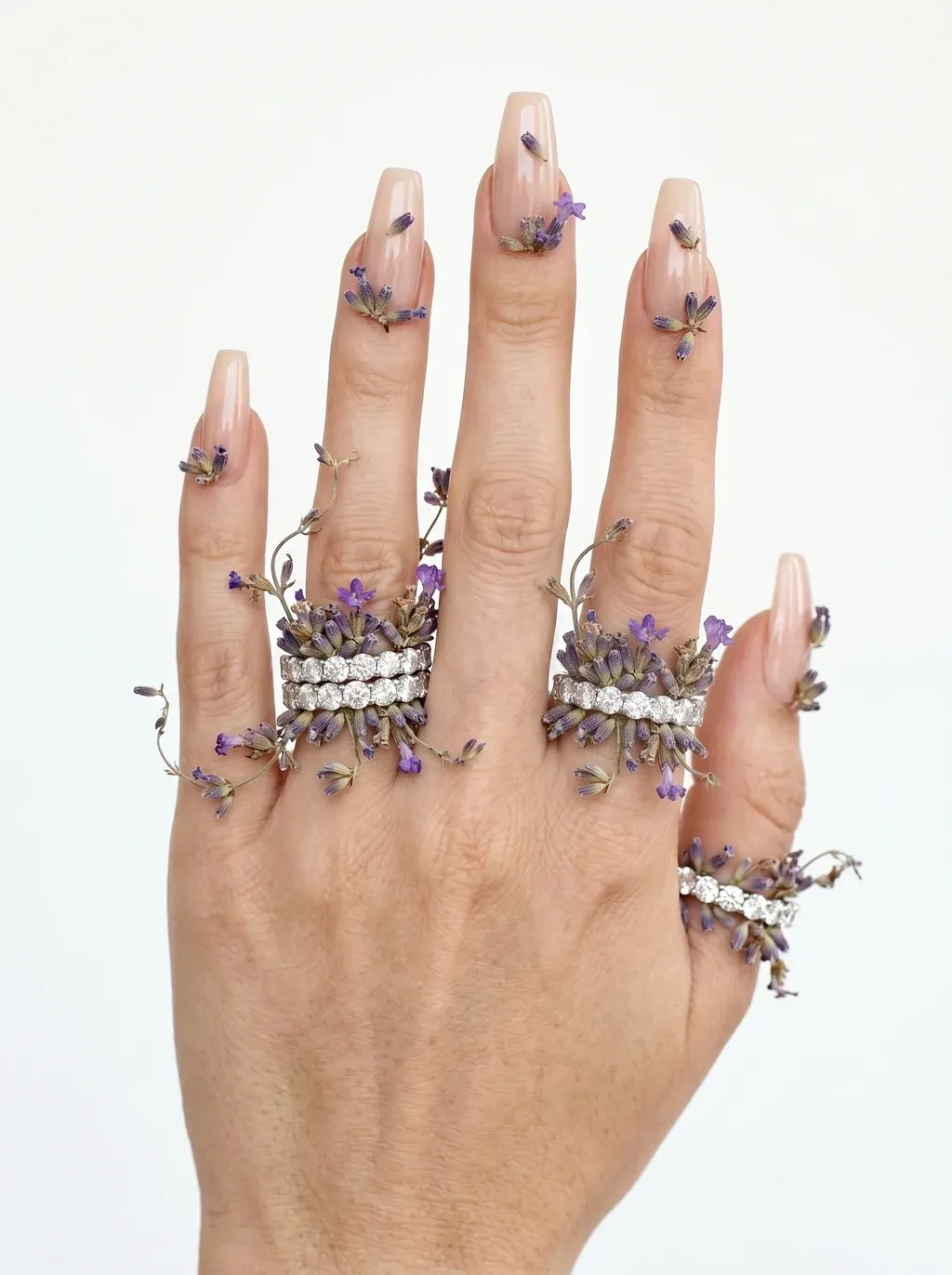 A high-fashion jewelry editorial close-up photograph of a woman's hand