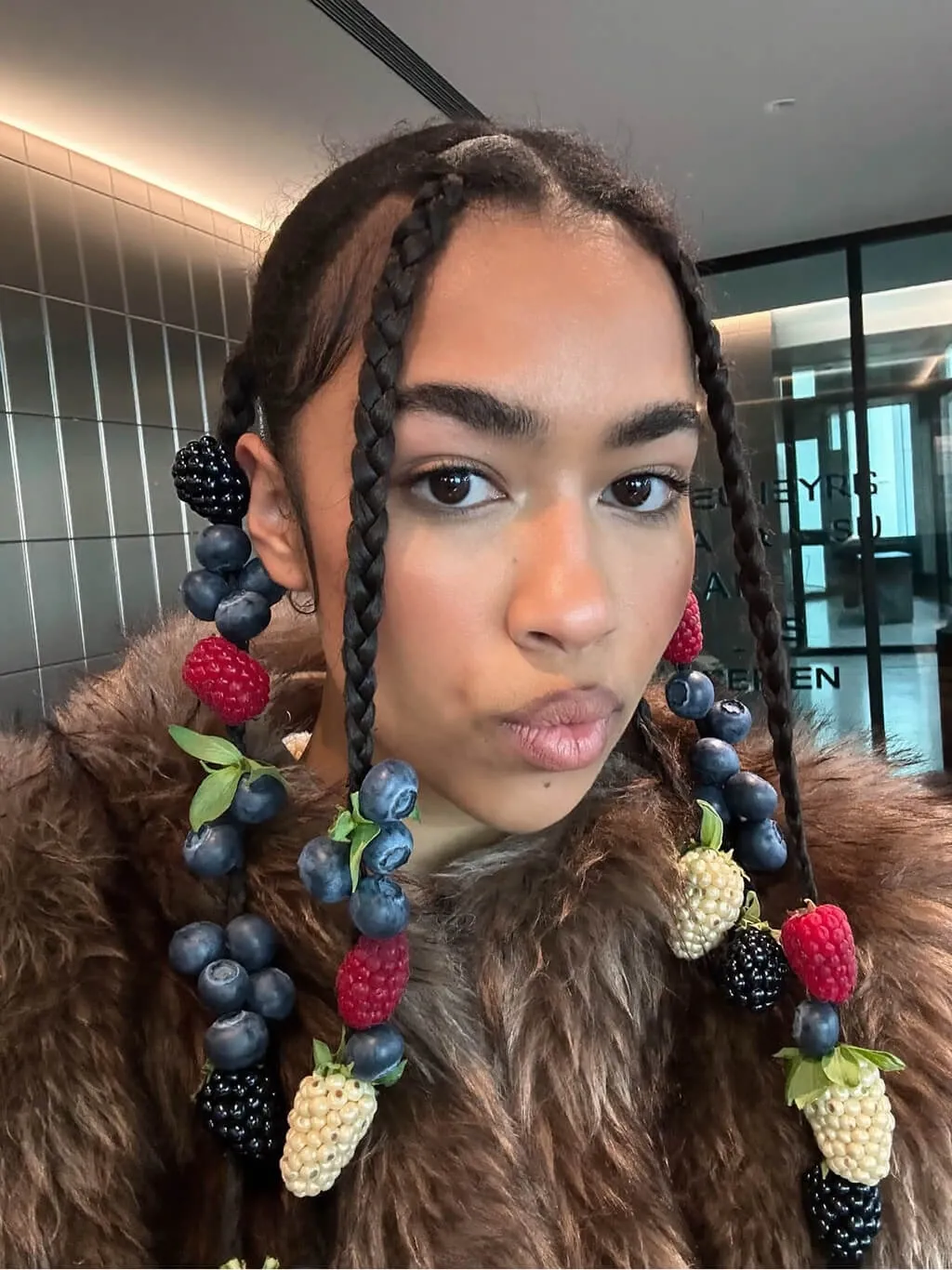 A fashion editorial selfie-style portrait of a mixed-race woman with