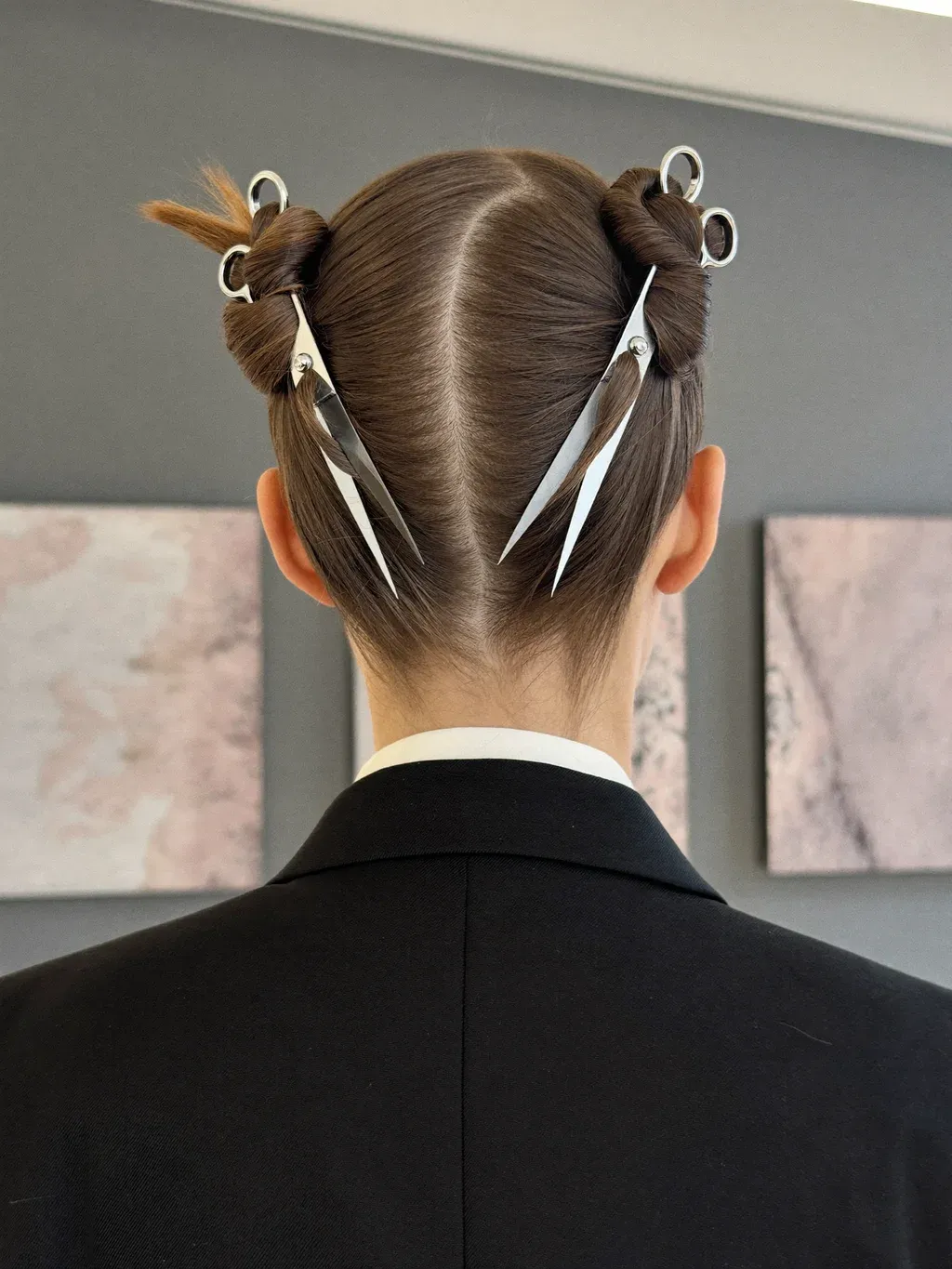 A close-up fashion editorial photograph shot from behind of a