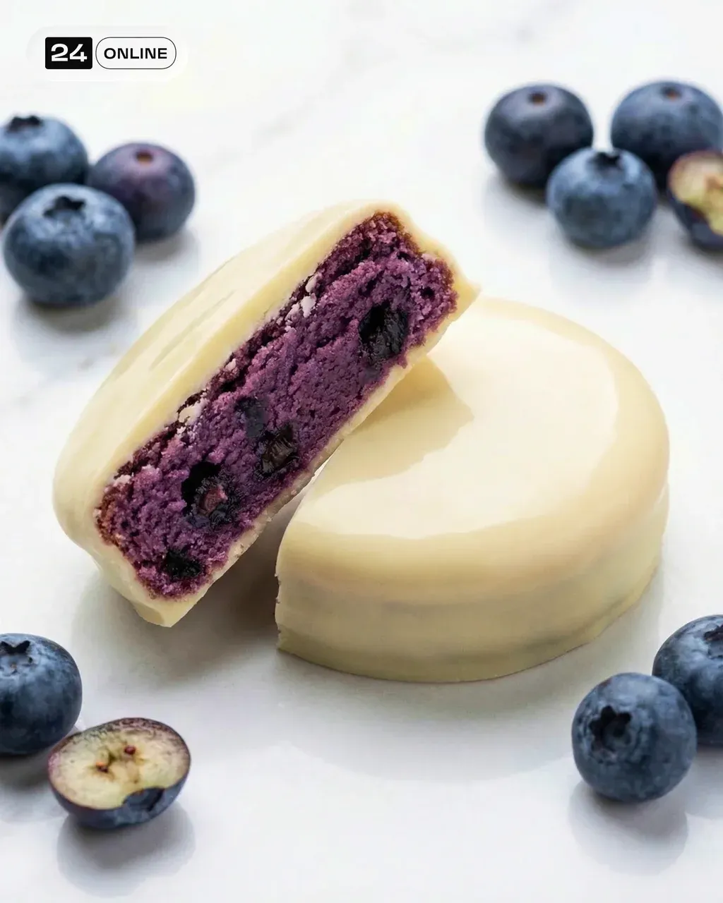 Two protein blueberry white chocolate brownies on white marble surface,