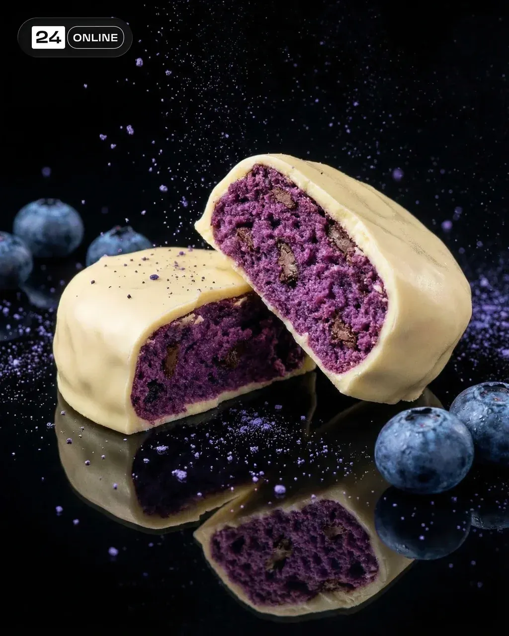 Protein blueberry white chocolate brownie cut in half on black
