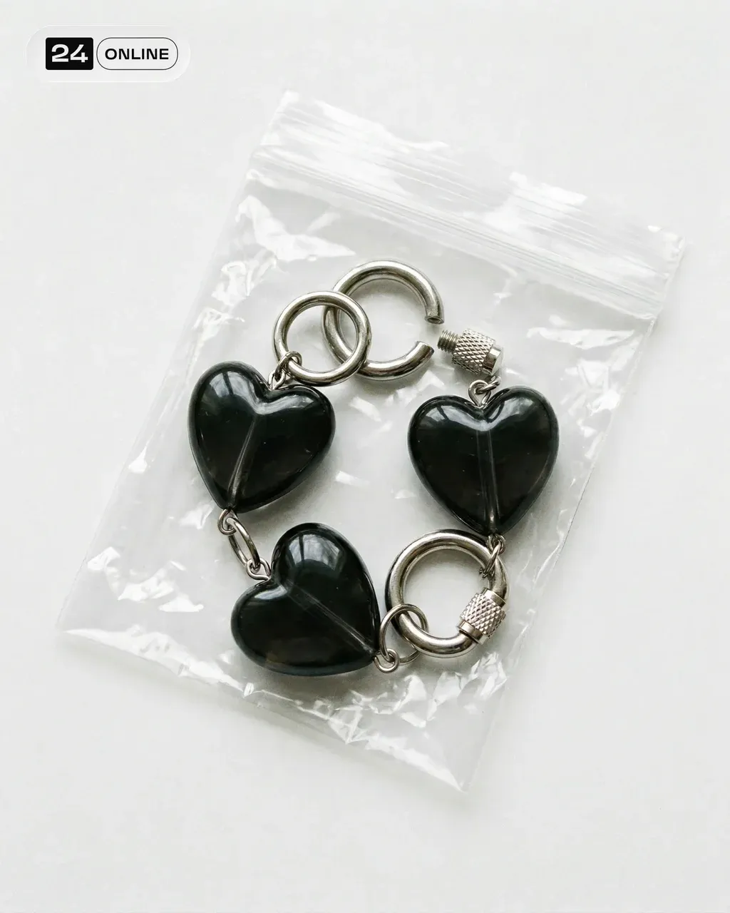 Minimal product photography of a chunky bracelet made from glossy