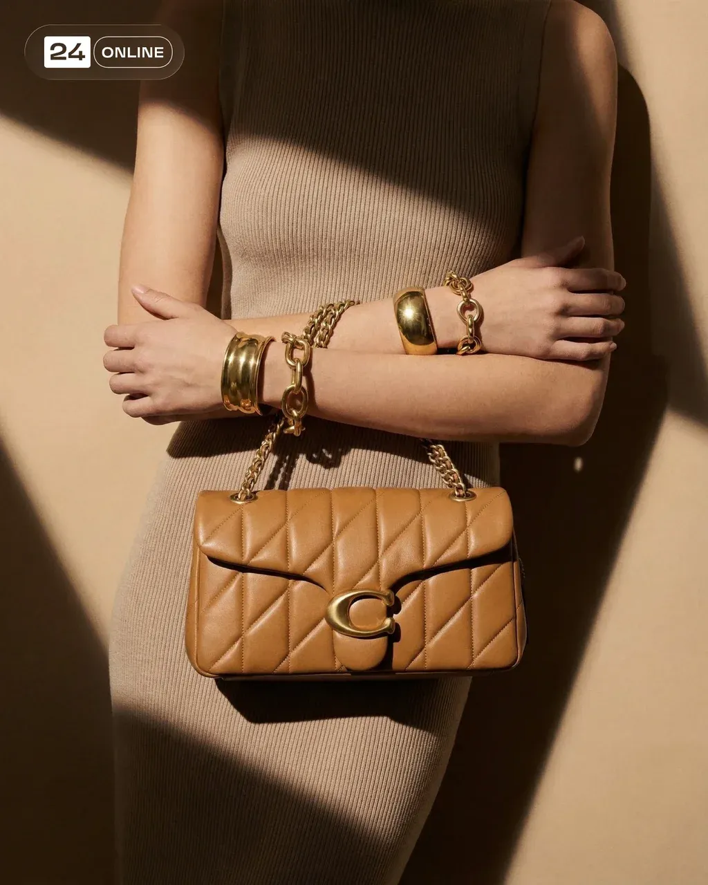 High-fashion editorial photograph of a beige and tan quilted leather