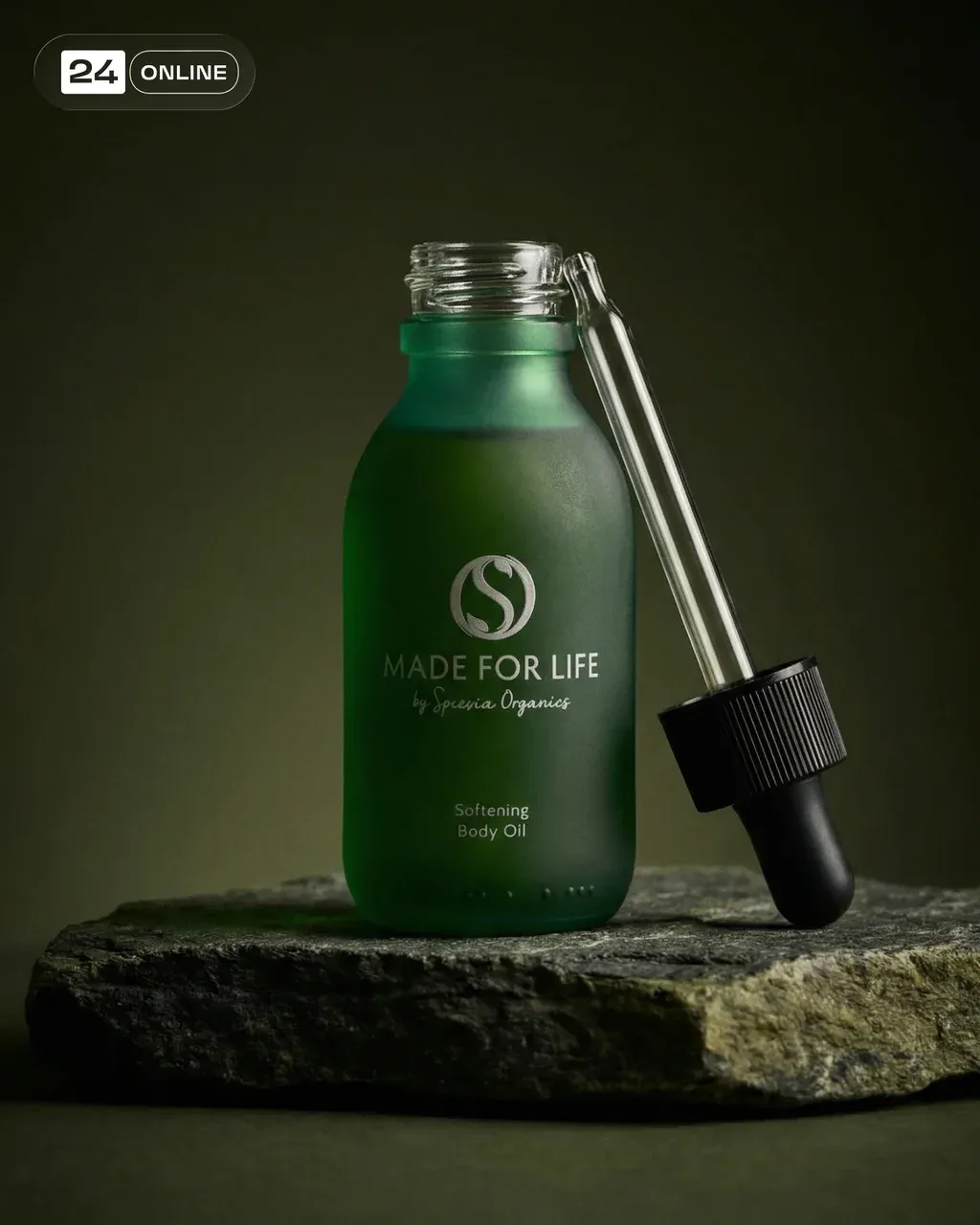 Luxury studio product photography of a frosted deep green glass