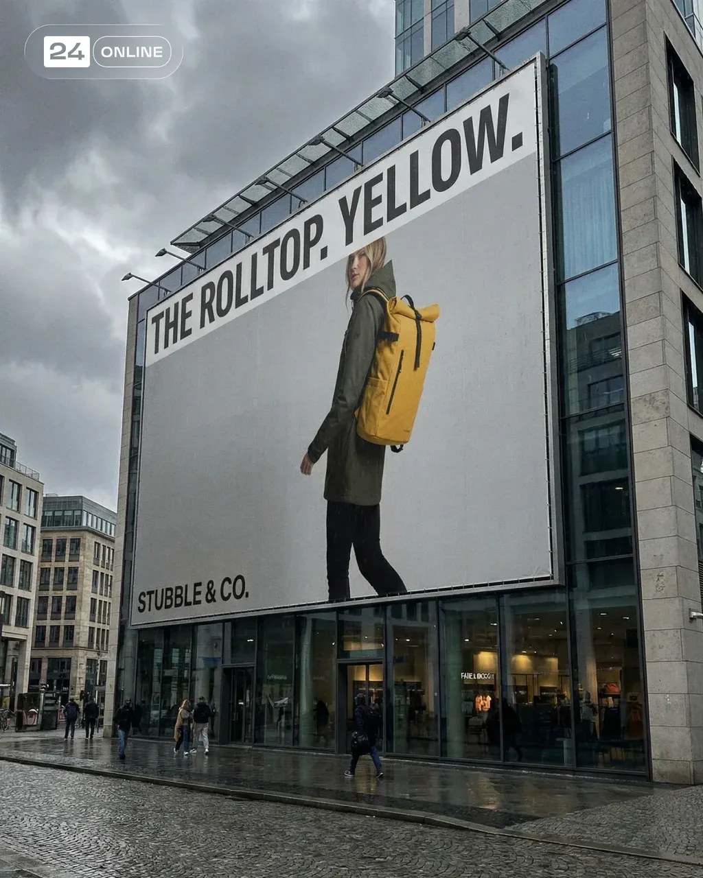 Large outdoor billboard in a modern European city featuring a