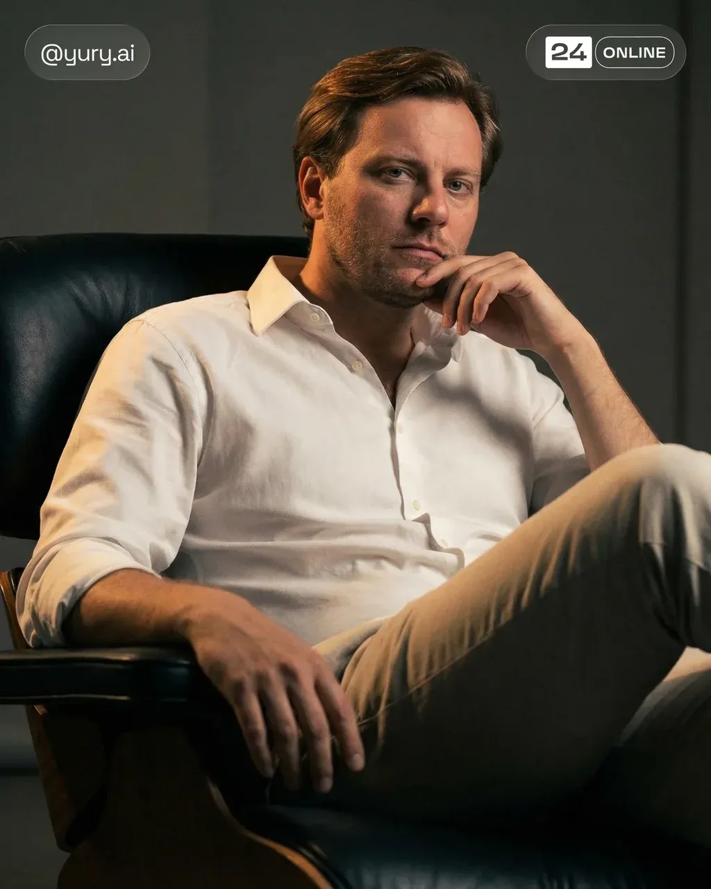 Create a portrait of this man (attached image) sitting in