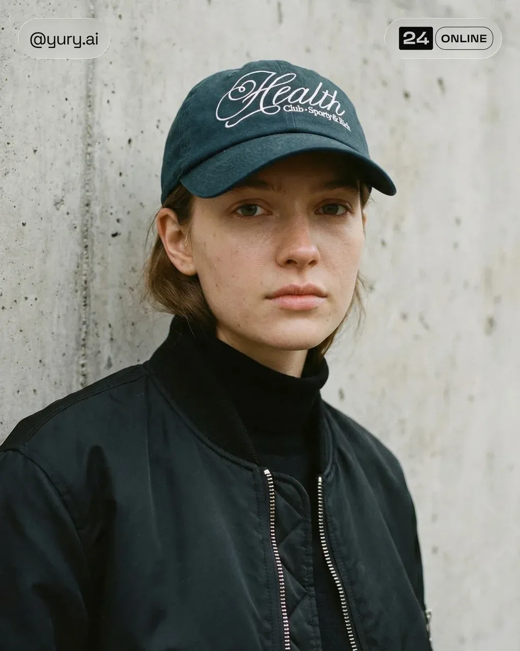 Editorial streetwear portrait of a young woman against raw concrete