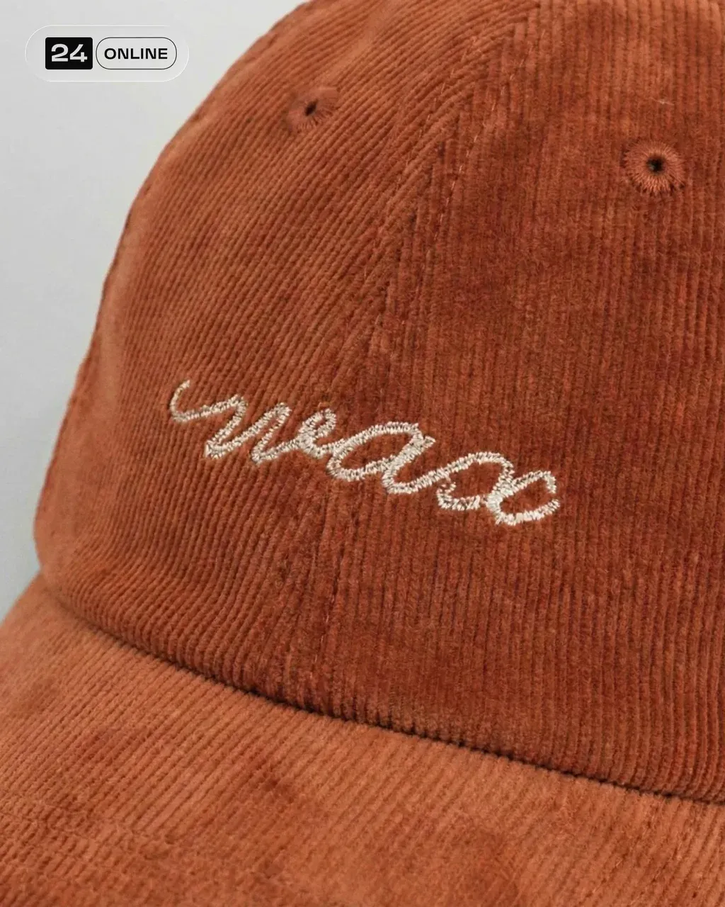 Editorial macro close-up of a PRODUCT , embroidered logo on