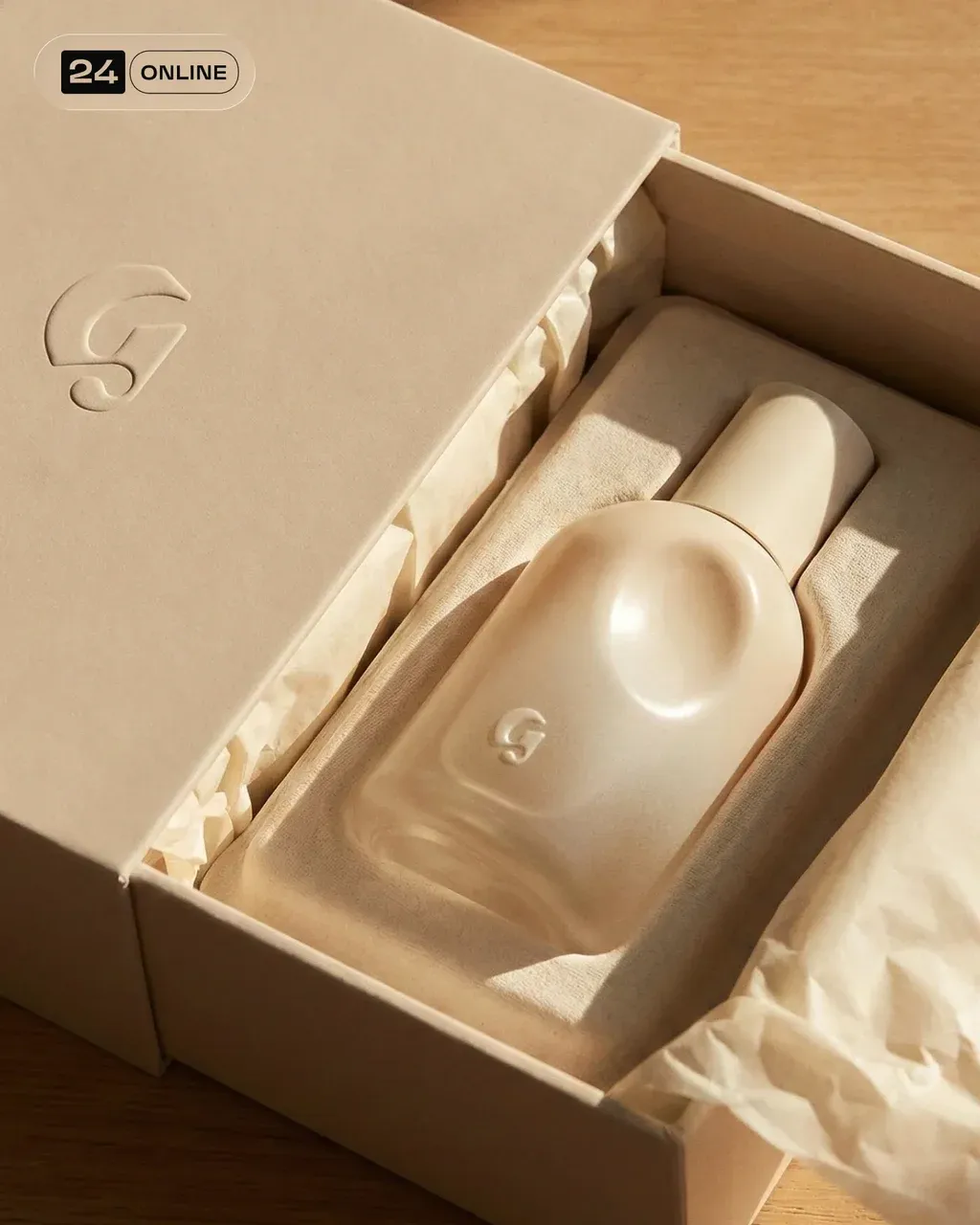 Premium unboxing-style shot of the PRODUCT perfume packaging. The matte