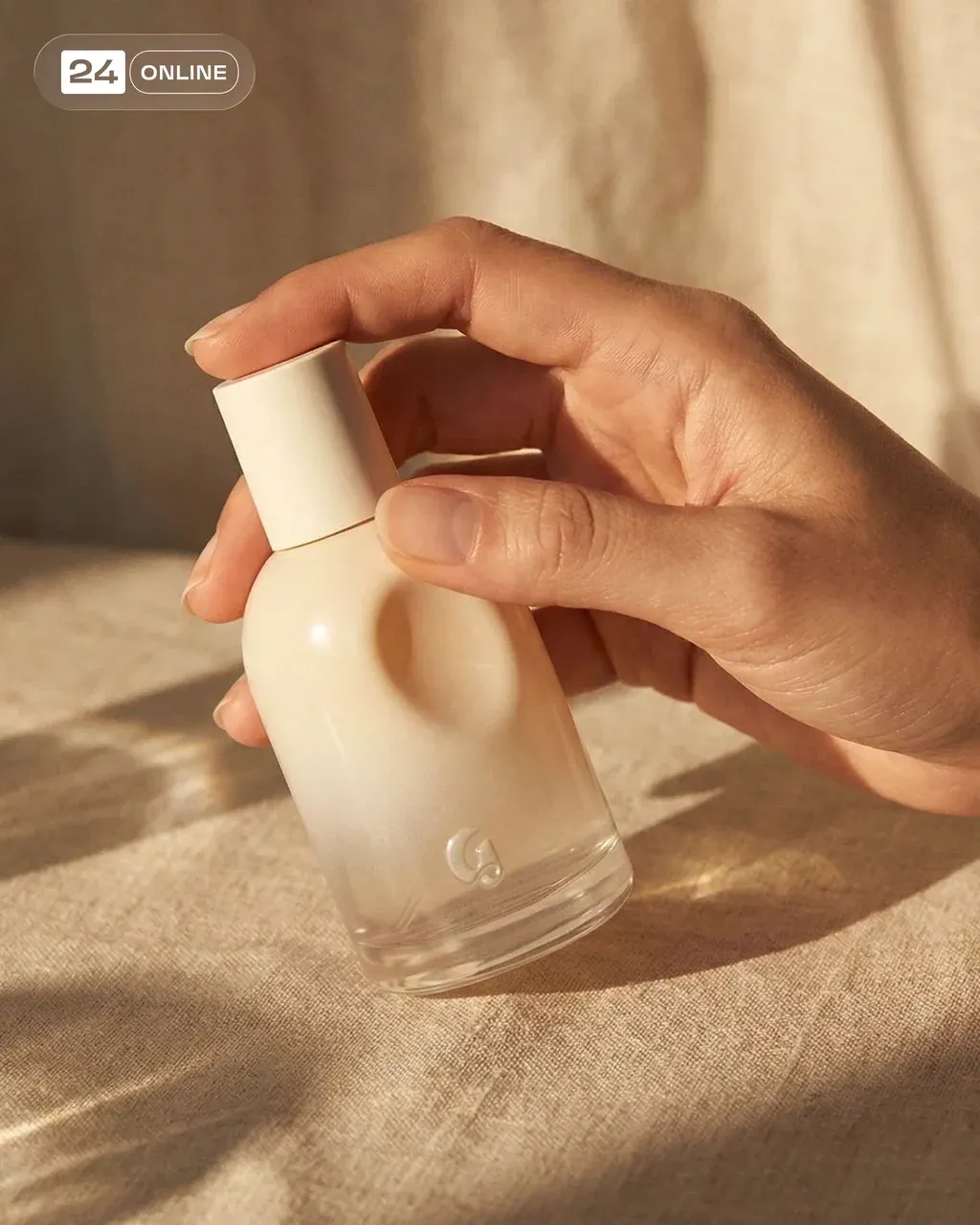 A premium editorial shot of a model’s hand gently holding