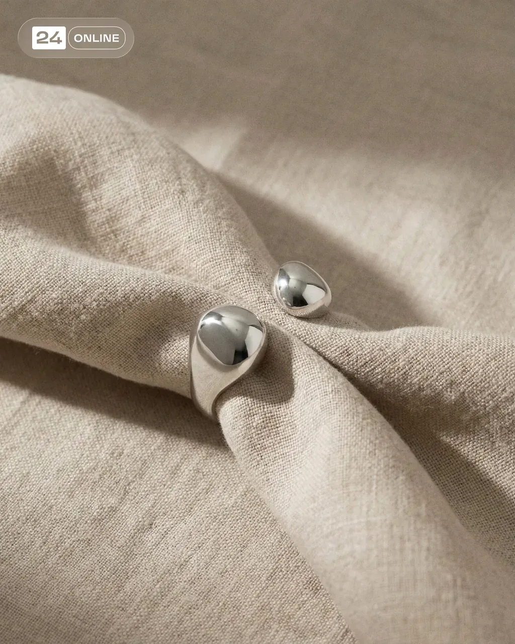 PRODUCT , placed on soft beige linen fabric with delicate
