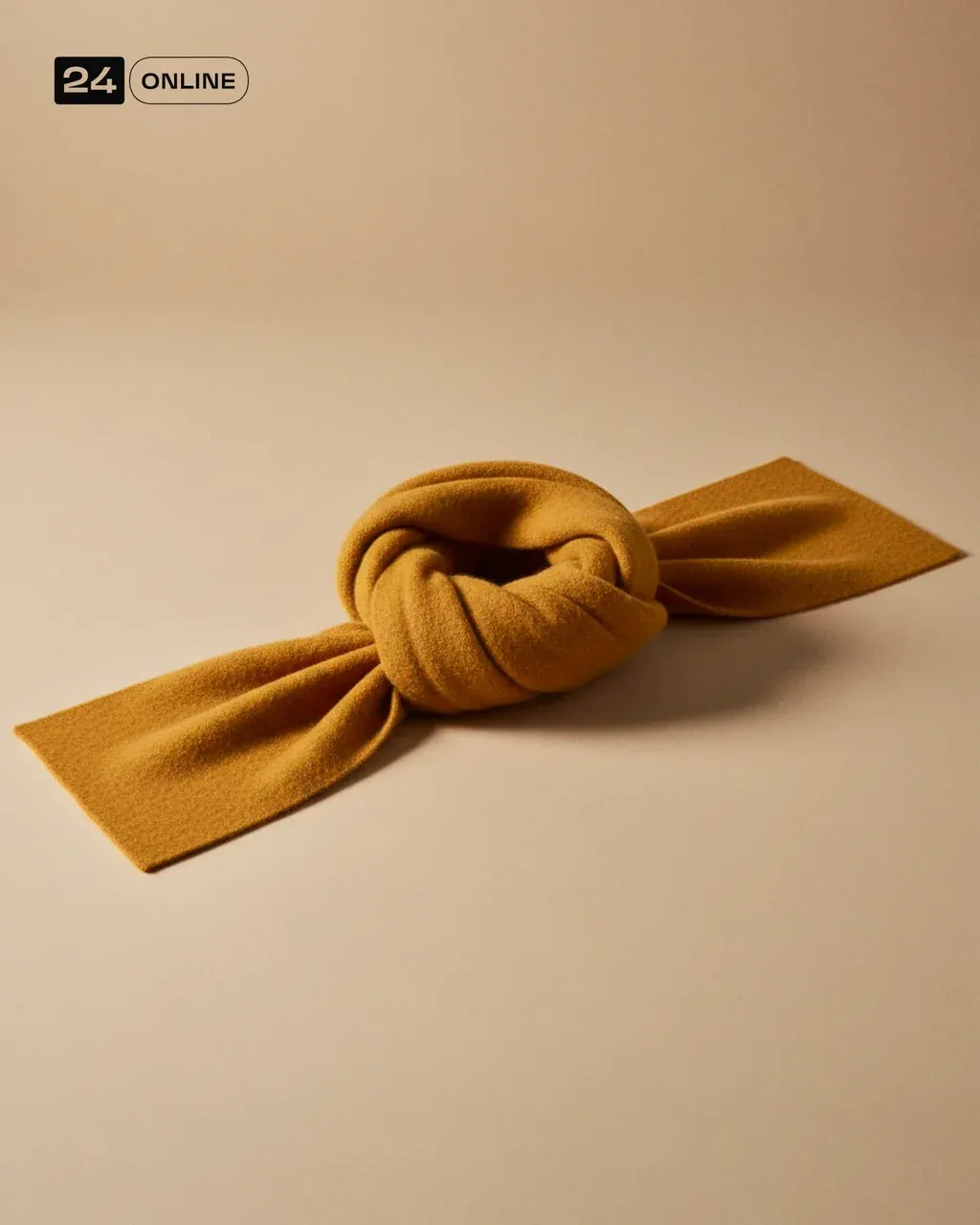 High-end editorial product photograph of a luxurious wool scarf in