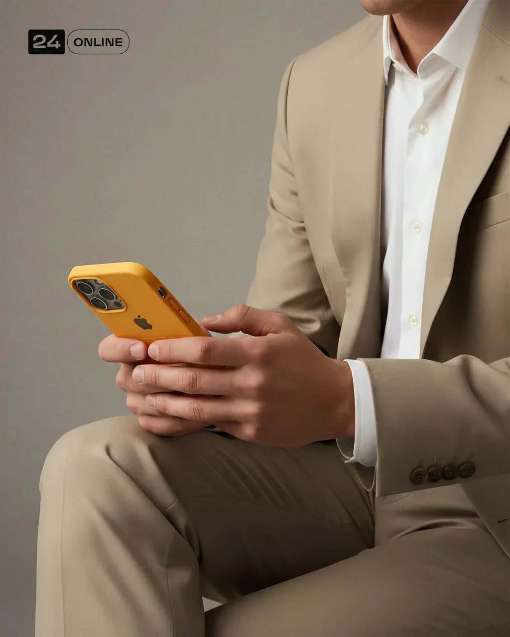 A man dressed in a beige suit and white shirt