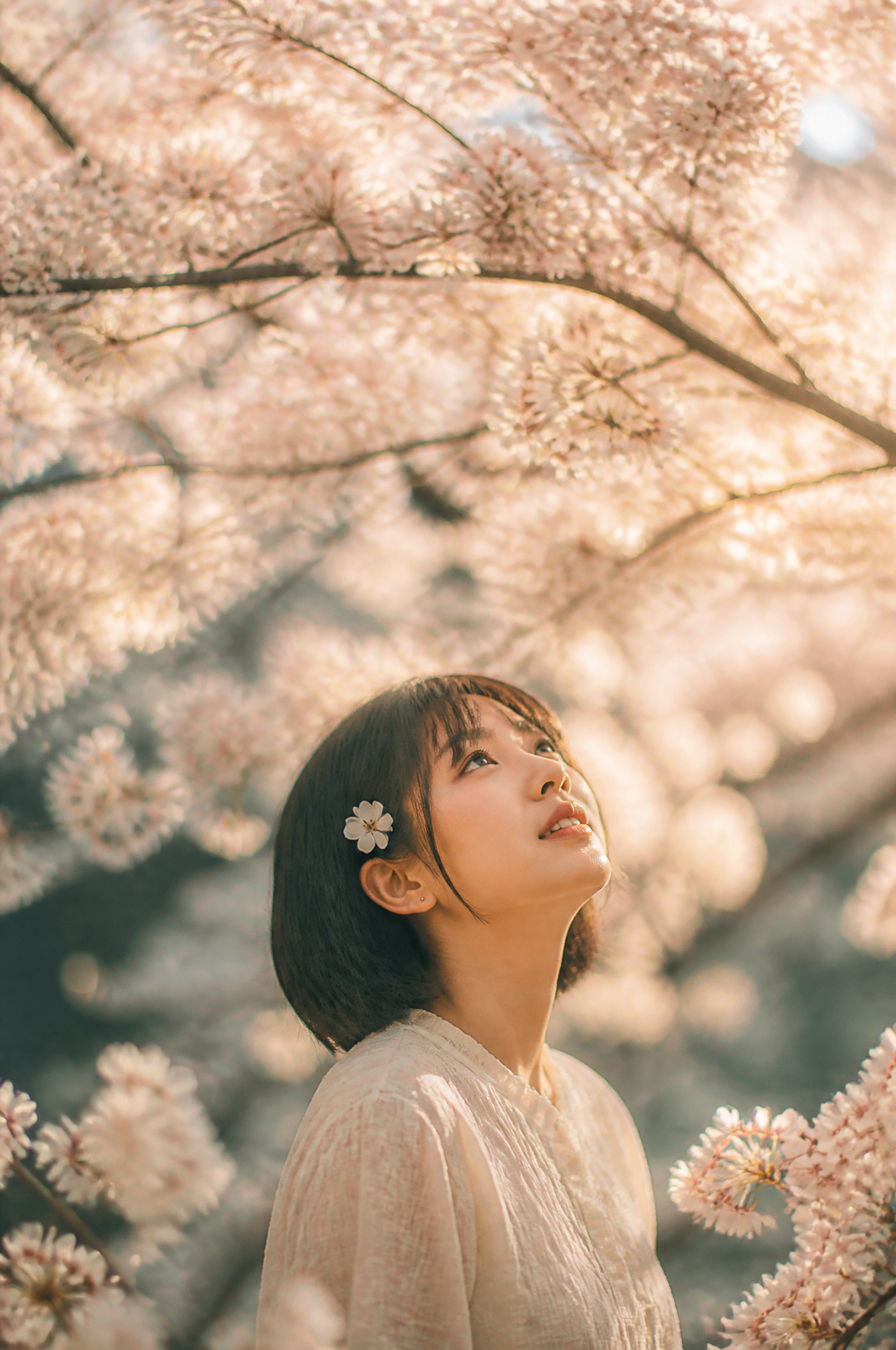 PROMPT : A cinematic portrait of a young East Asian woman with short dark hair and a smal…