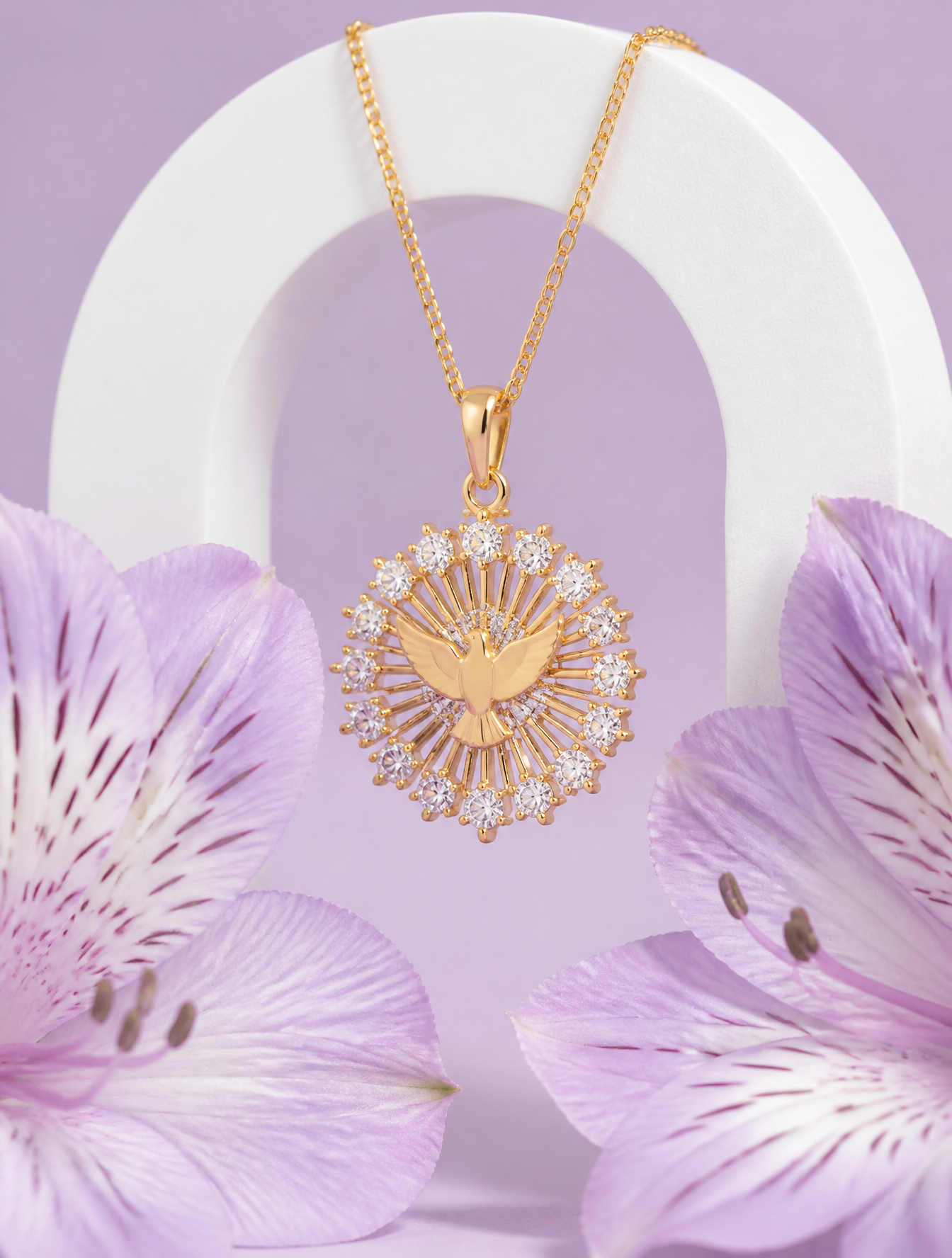 A delicate gold pendant featuring a central dove motif surrounded by a sunburst of radian…