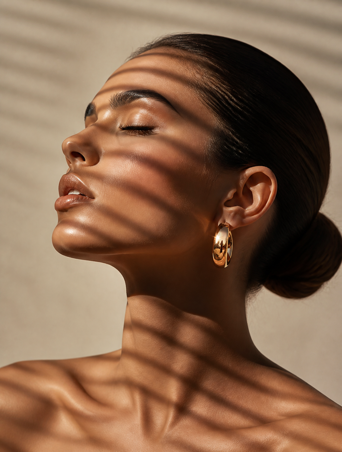 Close-up portrait of a woman showing only her head and shoulders, in profile, head tilted…