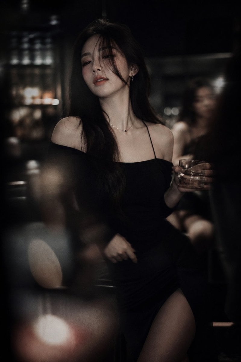 Low-light cinematic portrait, telephoto lens compression, shallow depth of field, intenti…